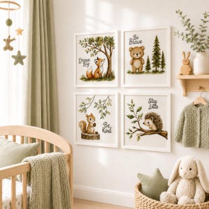 May include: Four square wall art prints featuring watercolor illustrations of a fox under a tree with the text Dream Big, a bear with the text Be Brave, a squirrel on a stump with the text Be Kind, and a hedgehog on a branch with the text Stay Little.