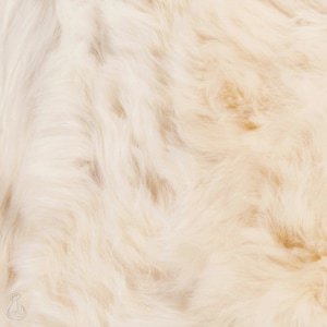 May include: Close-up of a soft, white, fluffy fur texture.