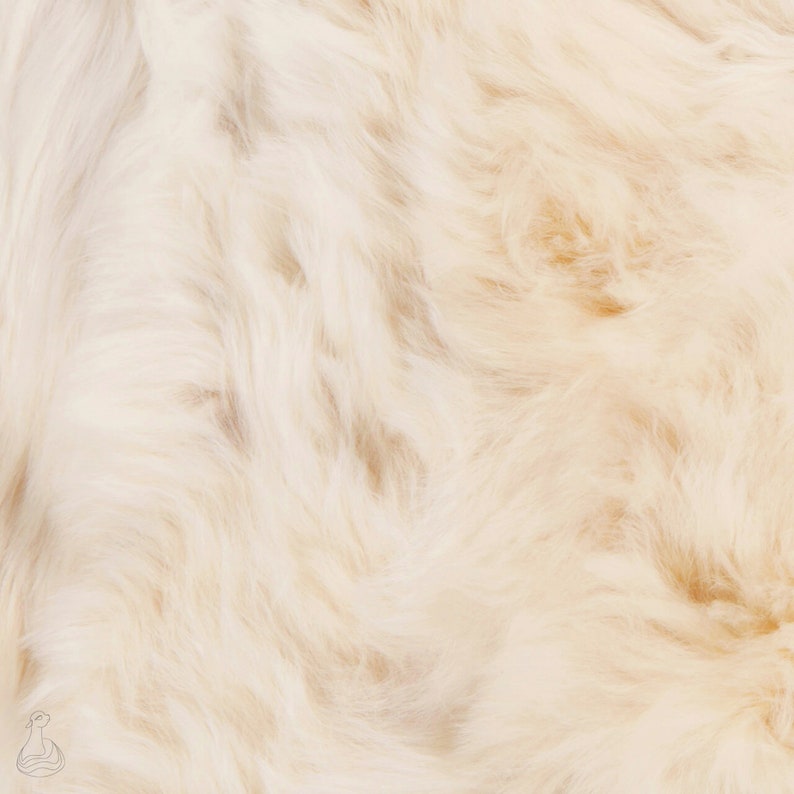 May include: Close-up of a soft, white, fluffy fur texture.