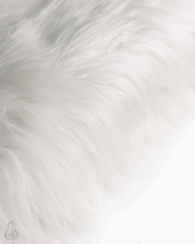 May include: White faux fur fabric with a soft, fluffy texture. The fur is arranged in a flowing, wave-like pattern.