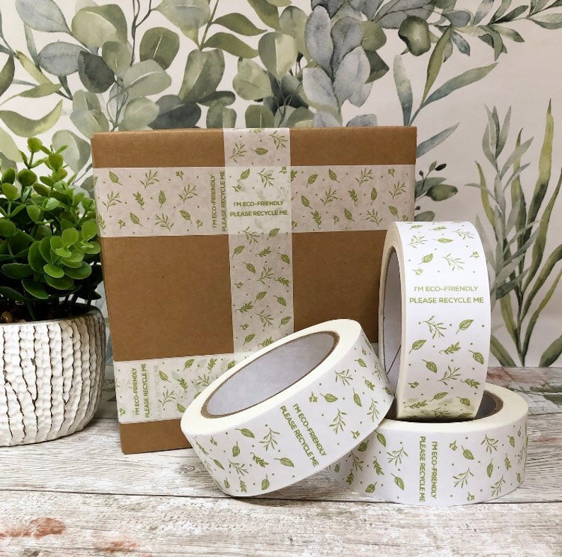 May include: Four rolls of white packing tape with a green leaf pattern and the text "I'm eco-friendly, please recycle me".