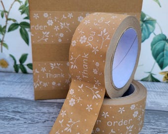 May include: Two rolls of brown paper tape with a white floral pattern and the text "Thank you for your order" printed on them.