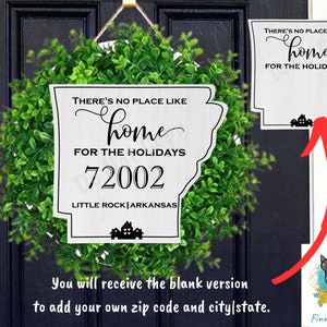 May include: A white wooden sign shaped like the state of Arkansas with the text "THERE'S NO PLACE LIKE home FOR THE HOLIDAYS 72002 LITTLE ROCK ARKANSAS". The sign is decorated with a small house icon and is surrounded by a green wreath.