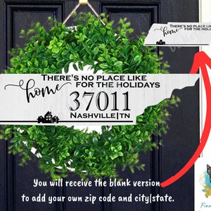 May include: White wooden sign shaped like the state of Tennessee with the text "THERE'S NO PLACE LIKE home FOR THE HOLIDAYS 37011 NASHVILLE|TN". The sign is hanging on a black door with a green wreath behind it. You will receive the blank version to add your own zip code and city/state.