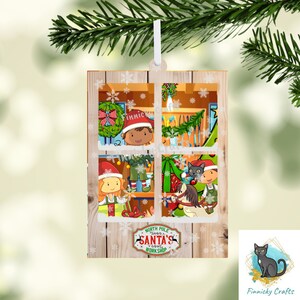 May include: A wooden Christmas ornament with a window scene of elves working in Santa's workshop. The window is framed in wood and has a snowy background. The text "North Pole Santa's Workshop" is on the bottom of the ornament.