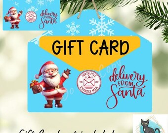 May include: A light blue envelope-shaped ornament with white snowflakes, featuring a yellow flap, a graphic of Santa Claus holding a gift, a North Pole Express Mail stamp, and the text "GIFT CARD" and "delivery from Santa".