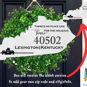 May include: A white wooden cutout of the state of Kentucky with the text "There's no place like home for the holidays" and "40502 Lexington Kentucky". The cutout is attached to a green wreath.