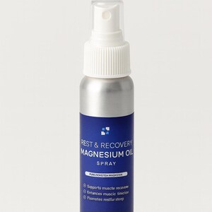 May include: A silver spray bottle with a white top and a blue label. The label reads "REST & RECOVERY MAGNESIUM OIL SPRAY." It supports muscle recovery, enhances muscle function, and promotes restful sleep. Contains 4 fl oz (118 ml).
