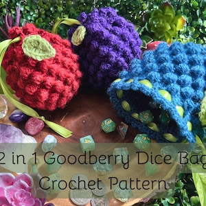 May include: Three crochet dice bags in red, purple, and blue, each featuring a textured bobble stitch pattern, a green leaf accent, and a ribbon drawstring. The blue bag is open, revealing polyhedral dice inside. Text reads: 2 in 1 Goodberry Dice Bag Crochet Pattern.