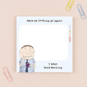 May include: A light blue notepad with the text "Here we f**king go again" and "I mean Good Morning". A cartoon man is holding a purple mug. Pink, yellow, and blue paper clips are scattered around the notepad.