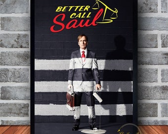 May include: A framed wall art canvas featuring the text "Better Call Saul" in red and yellow. The image depicts a man in a suit with a red tie, holding a briefcase and paint roller, with a black and white striped background.