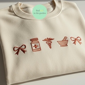 Embroidered Nurse Icon Sweatshirt, Cute Medical Symbol Crewneck for Nursing Students, RN Gift Healthcare Worker Appreciation Shirt for Women
