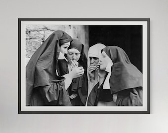 May include: A black and white framed photograph depicting four individuals dressed in traditional religious habits. Three of the figures are actively lighting and smoking cigarettes, while the fourth figure observes the action in this candid scene.