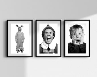 May include: Three black and white framed prints displayed side by side. The left print shows a person in a rabbit costume. The center print features a person in an elf hat with an open mouth. The right print shows a person with hands on cheeks.