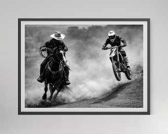 May include: Black and white framed print featuring a cowboy on horseback and a motocross rider. The cowboy wears a hat and holds a lasso, while the rider is airborne on a dirt bike. The image captures action and movement.
