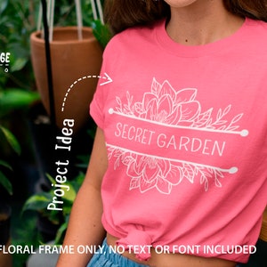 May include: A pink t-shirt featuring a white floral design and the text "SECRET GARDEN".