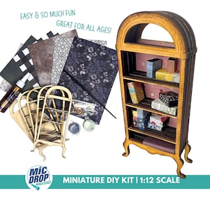 Op de afbeelding: Een miniatuur DIY-kit voor het bouwen van een houten boekenkast. De kit bevat een voorgeknipte houten boekenkast, decoratief papier, verf en andere knutselbenodigdheden. De afgewerkte boekenkast is op schaal 1:12.