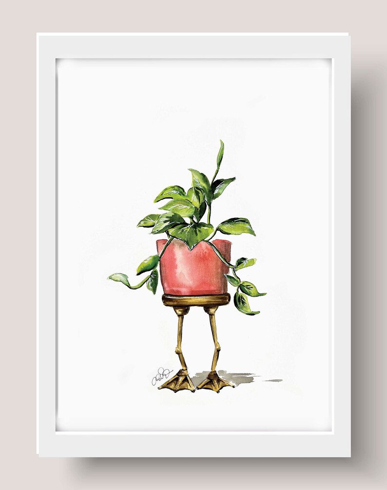 May include: A watercolor painting of a potted plant with green leaves. The pot is pink and has gold legs shaped like bird feet.