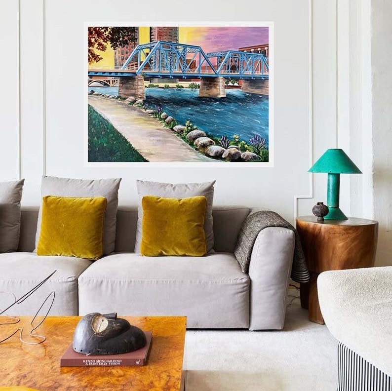 K&ouml;nnte beinhalten: Ein Gem&auml;lde, das eine blaue Br&uuml;cke &uuml;ber einem Fluss zeigt, mit einer Skyline im Hintergrund. Das Gem&auml;lde ist in einem realistischen Stil gehalten und zeigt eine Vielzahl von Farben, darunter Blau, Gr&uuml;n und Braun.