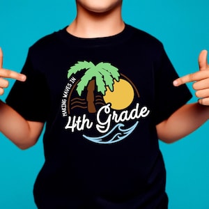 May include: Black t-shirt with a colorful graphic design. The design features a palm tree, sun, and waves, with the words "Making Waves in 4th Grade" in white script. The shirt is worn by a child.