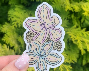 Puede incluir: Una pegatina con dos flores estilizadas con acentos amarillos, rosas y azules. Las flores están delineadas en negro y tienen un fondo blanco.