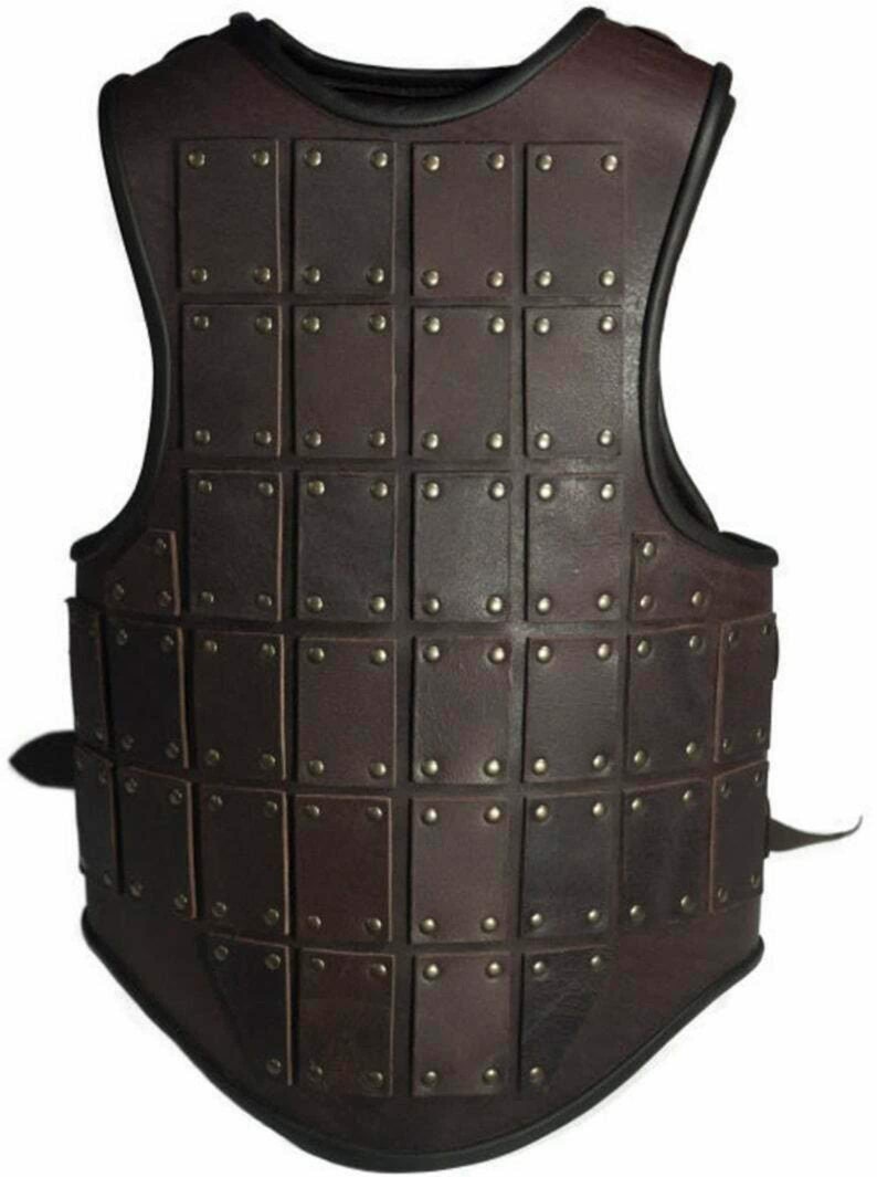 May include: A brown leather vest with a grid pattern of square leather plates, each secured with a metal rivet. The vest has a black trim around the neckline and armholes.