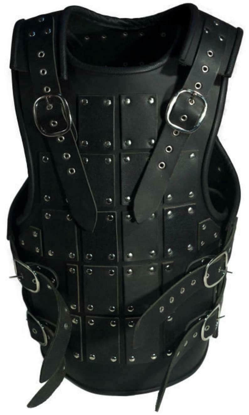 May include: Black leather armour with metal rivets and buckles. The armour is made of multiple leather panels that are stitched together. The armour has a strap that goes over the shoulders and buckles at the front.