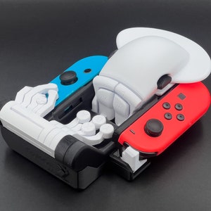 May include: A white and blue Nintendo Switch controller with a white and red Joy-Con controller attached. The controllers are connected to a white plastic accessory with a white and blue design.