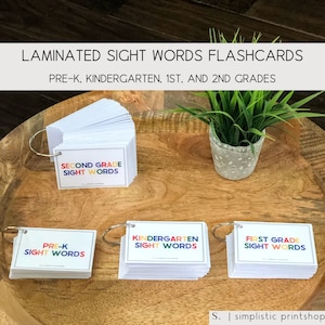 May include: Four sets of laminated sight word flashcards for Pre-K, Kindergarten, First Grade, and Second Grade. Each set is organized in a ring binder.