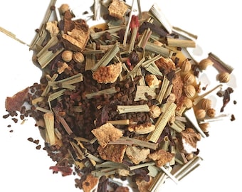 May include: A close-up of a blend of loose leaf tea with dried orange peel, lemongrass, hibiscus, and coriander seeds.