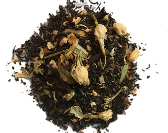 May include: A close-up of a blend of black tea leaves, orange peel, and white jasmine flowers. The tea is loose leaf and ready to be brewed.