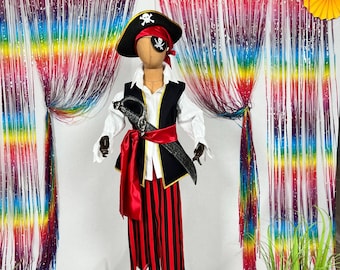 May include: A pirate costume on a mannequin. The outfit features a black hat with a skull and crossbones, a white shirt, a black waistcoat with gold trim, red and black striped trousers, and a red sash. A toy sword is included.