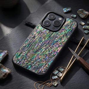 May include: A set of three ceramic mugs with a speckled, matte finish. The mugs are in shades of cream, light gray, and dark gray. Each mug has a simple, minimalist design and a rounded handle.