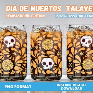 May include: Three 16oz glass cans with a Day of the Dead theme. The cans feature a black background with orange and yellow floral designs, sugar skulls, and the text "Dia de Muertos Talavera, Cempasuchil Edition".