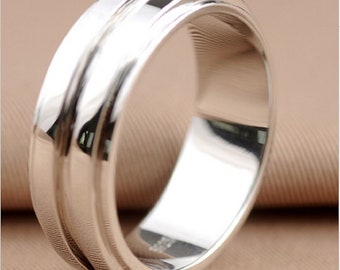 May include: A silver ring with a smooth, polished finish and two raised bands around the center.