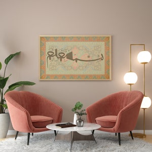 May include: Two pink armchairs with a white marble coffee table in front of a framed artwork with Arabic calligraphy and a floral design. A floor lamp with three white globe lights is in the corner.