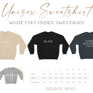 May include: A unisex sweatshirt available in three colors: sand, black, and dark heather gray. The sweatshirt has a white font that says "SAND", "BLACK", and "DARK HEATHER GRAY" on each color. The size chart shows the width, length, and sleeve length in inches for sizes S through 5XL. The chart also includes the brand name "GILDAN 18000".