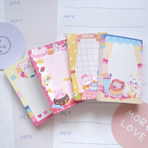 May include: Four pink, yellow and blue patterned sticky notes with cute cartoon bears and text that says "10000" and "Happy Birthday".