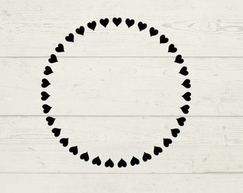 May include: A black and white graphic design of a circle frame with a border of small hearts. The design is on a woodgrain background.