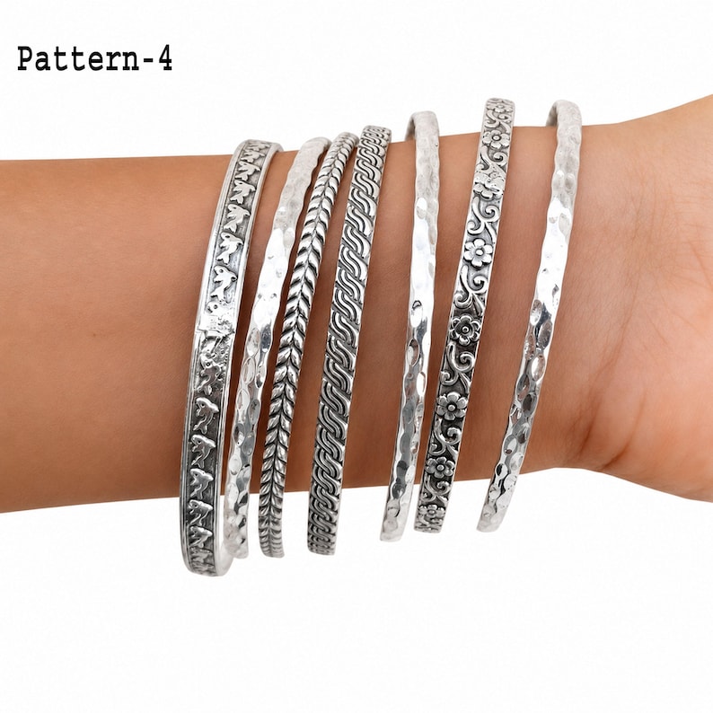 Detailed view of handmade silver bangle designs, including floral, leaf, elephant, wave, and oxidized pattern details.