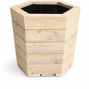 May include: A hexagonal wooden planter constructed from light-coloured horizontal planks. The exterior features a natural wood grain finish with visible knots and texture. The interior is lined with a black fabric material, creating a contrast.