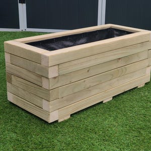 May include: A rectangular wooden planter box with a black liner. The planter is made of natural wood and has a rustic look.