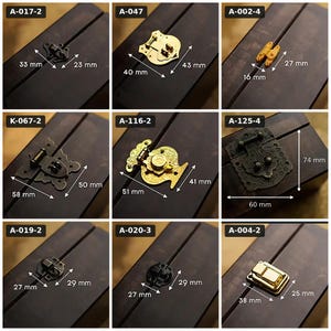 May include: A collection of nine metal box latches and hinges displayed on dark wood surfaces. Each item is labeled with a code and includes white arrows indicating dimensions in millimeters, such as 33 mm by 23 mm, 40 mm by 43 mm, and 60 mm by 74 mm.