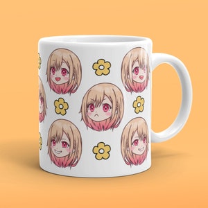 May include: White ceramic mug featuring a repeating pattern of a cartoon anime girl with various facial expressions and yellow flowers.
