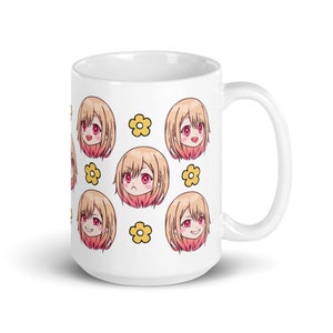 May include: White ceramic mug featuring a repeating pattern of a cartoon anime girl with pink cheeks and red eyes, and a yellow flower.