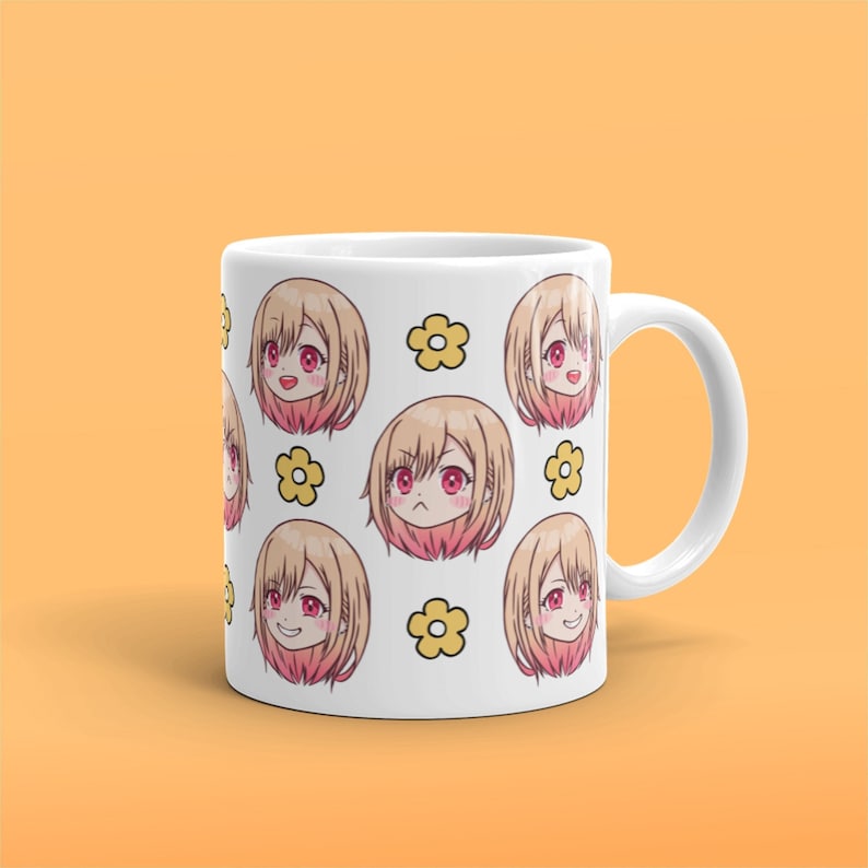 May include: White ceramic mug featuring a repeating pattern of a cartoon anime girl with various facial expressions and yellow flowers.