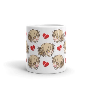 May include: White ceramic mug with a repeating pattern of a cartoon character with blonde hair and a red broken heart. The character has a frustrated expression.
