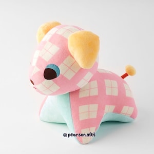 May include: Pink and white plaid plush toy dog with yellow ears and a red tail. The dog is sitting on a white background.