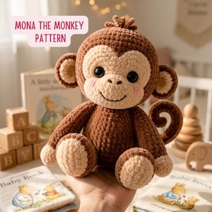 May include: A crocheted monkey doll in shades of brown and beige, with a smiling face and rosy cheeks. The doll has large black eyes and is holding a book. The text "MONA THE MONKEY PATTERN" is displayed in a pink box.