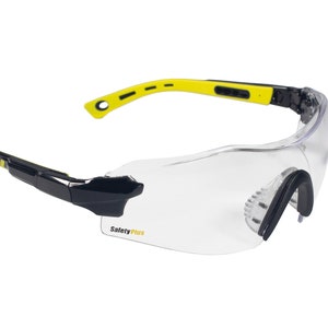 May include: Clear safety glasses with black and yellow accents. The glasses have a wraparound design with a clear lens and the text "Safety Plus" printed on the lens.